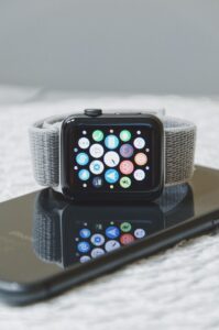 black Apple Watch with gray band on iPhone